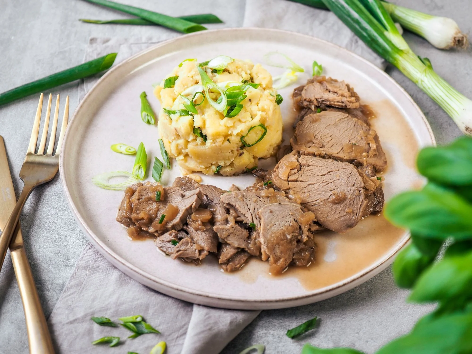 Pork tenderloin with onion dressing and crushed potatoes